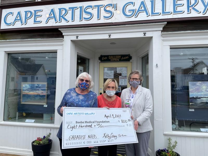 Cape Artists’ Gallery Chair Kathy Casey (l-r) and Cape Artists’ Group President Pat Riordan present their gift to Beebe Medical Foundation Executive Director of Development Kay Young. SUBMITTED PHOTO